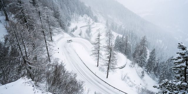 Snowy road with a camper driving