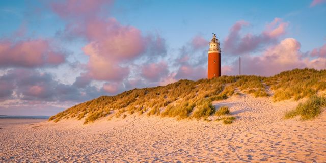 Camping in Holland by the sea: lighthouse at sunset