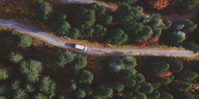 A CamperBoys van on a road in Tyrol from above.