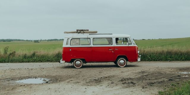 VW Bulli in front of a grass field