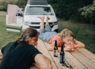 Vater und Tochter beim Campen im California Beach - Machen Pause an Holztisch