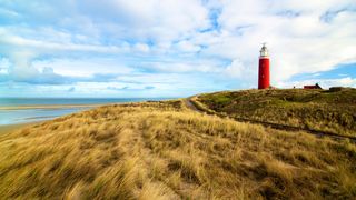 Lighthouse on a hill by the sea in the Netherlands