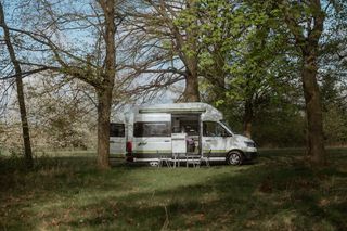 Off Camper auf einem Campingplatz umgeben von Wald