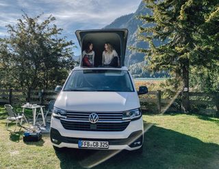 VW California Ocean with two girls in the roof bed