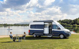 VW Grand Califonia 680 in front of a lake