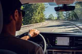 Camper with man is driving on a street