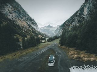 VW California Beach on valley road between two mountains